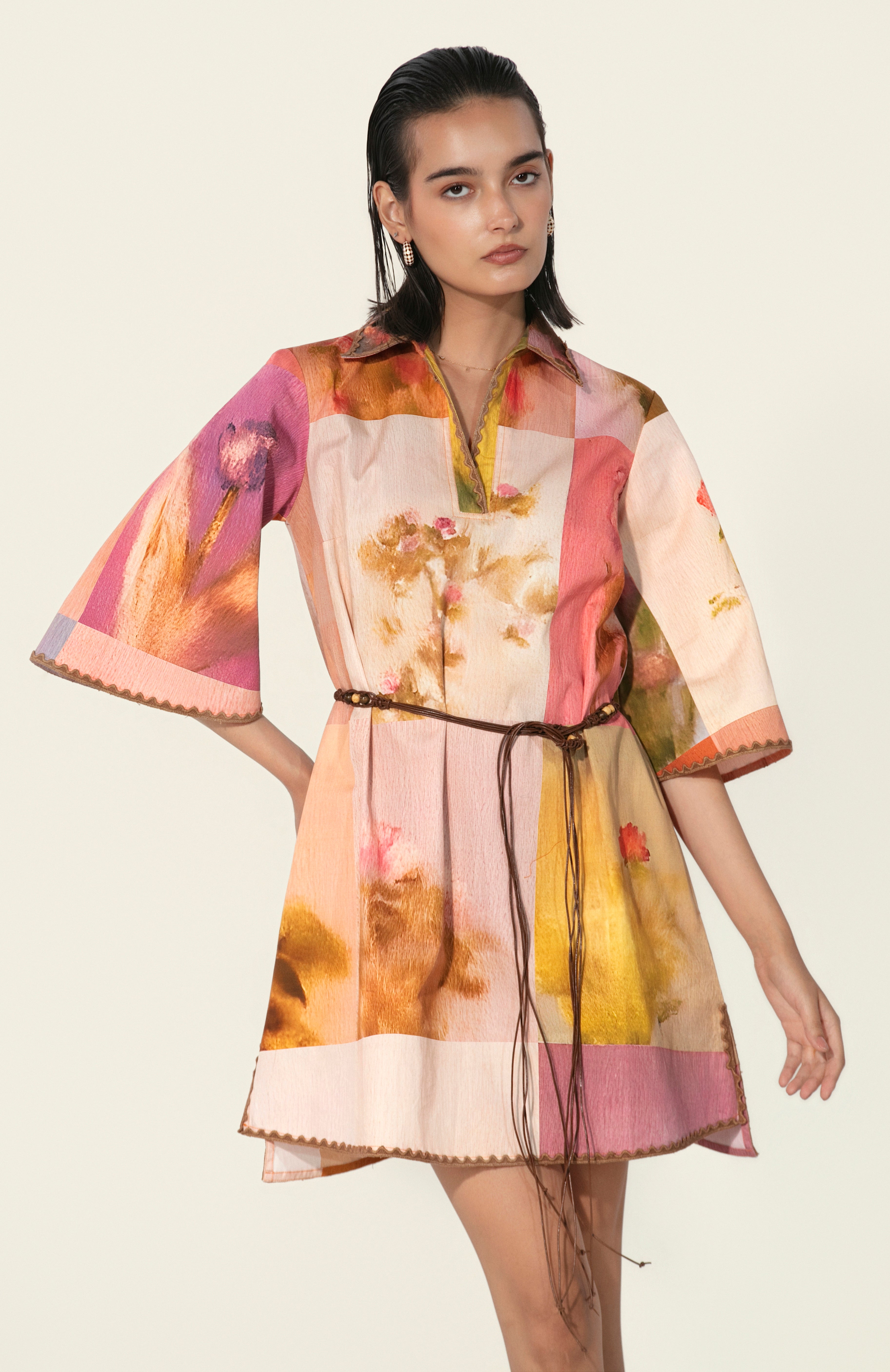 Model wearing a multicolor printed belted mini dress with wide sleeves from Thr3letter premium women's western wear collection.