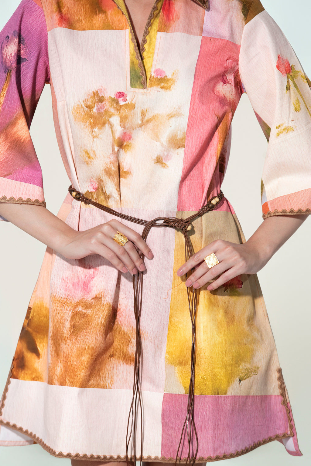 Model wearing a multicolor printed belted mini dress with wide sleeves from Thr3letter premium women's western wear collection.